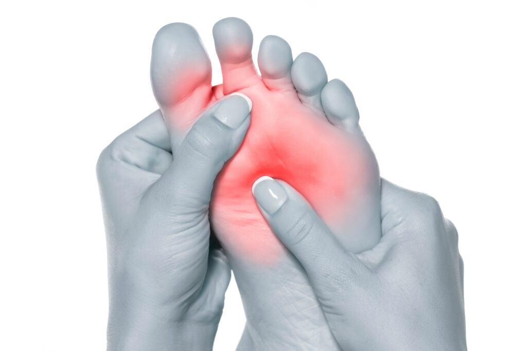 Black and white image of foot, with red glowing around the ball of the foot to signify pain.