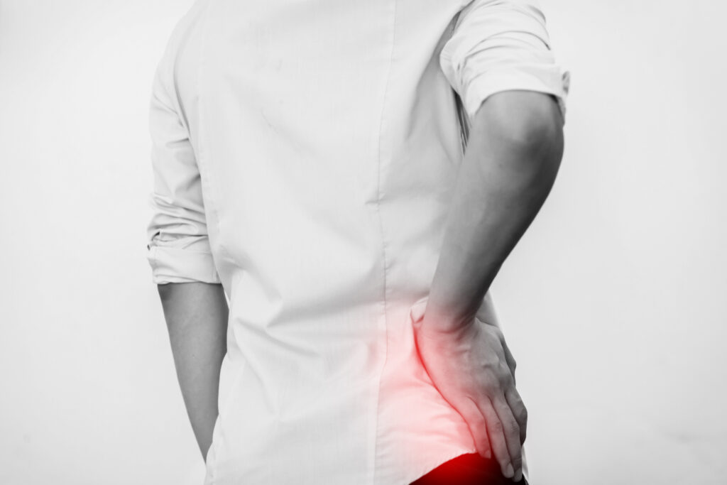 Black and white image of hip and upper body, with red glowing around the hip to signify pain.